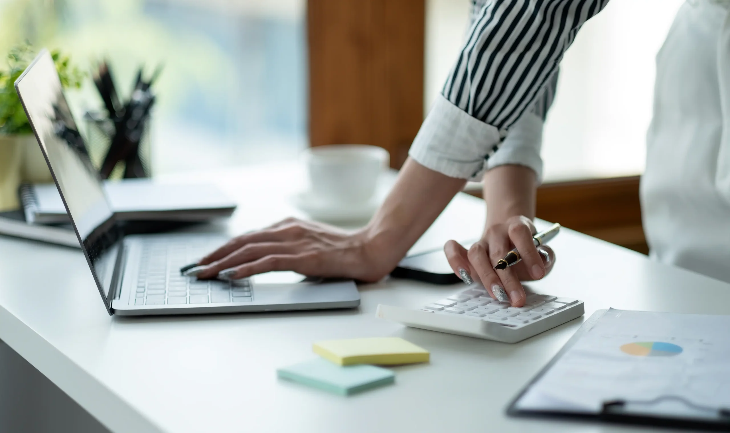 close-up-business-woman-using-calculator-laptop-math-finance-wooden-desk-tax-accounting-statistics-analytical-research-concept